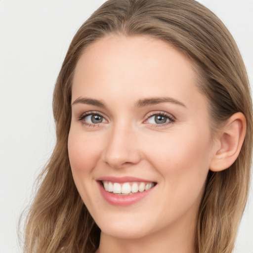 Joyful white young-adult female with long  brown hair and blue eyes