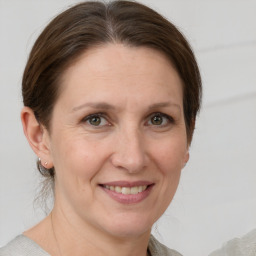 Joyful white adult female with medium  brown hair and grey eyes