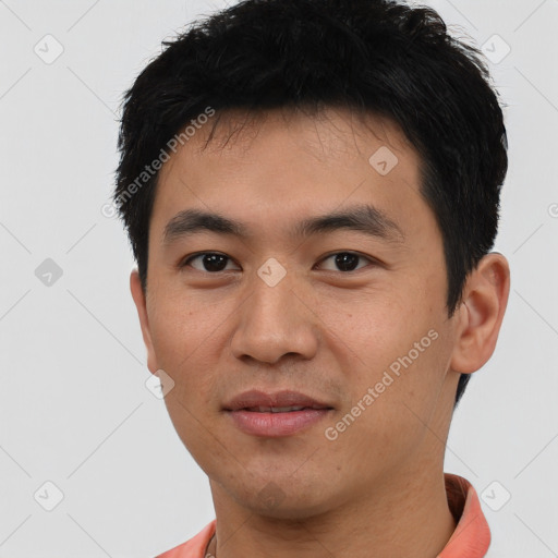 Joyful asian young-adult male with short  black hair and brown eyes