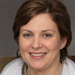 Joyful white adult female with medium  brown hair and brown eyes