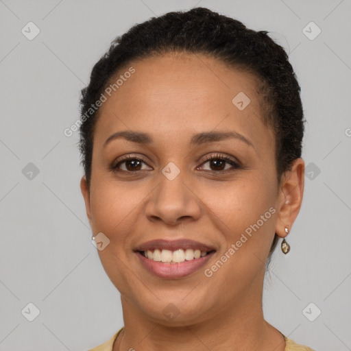 Joyful latino adult female with short  brown hair and brown eyes