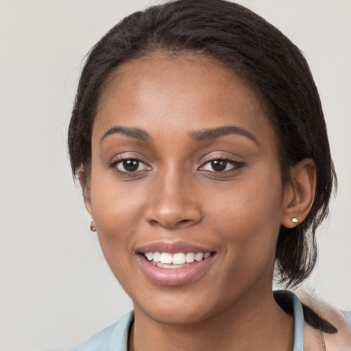 Joyful black young-adult female with medium  brown hair and brown eyes