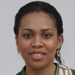 Joyful black young-adult female with short  brown hair and brown eyes