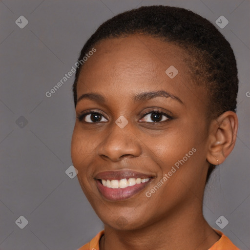 Joyful black young-adult female with short  brown hair and brown eyes