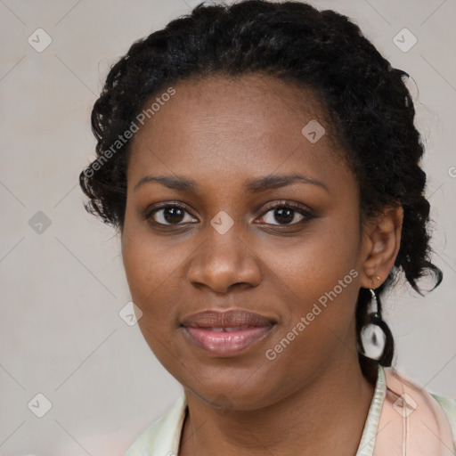 Joyful black young-adult female with long  brown hair and brown eyes