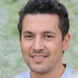 Joyful white young-adult male with short  black hair and brown eyes