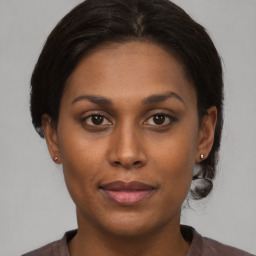 Joyful latino young-adult female with medium  brown hair and brown eyes