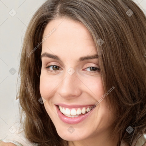 Joyful white young-adult female with long  brown hair and green eyes