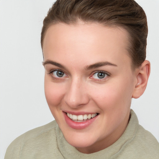 Joyful white young-adult female with short  brown hair and grey eyes