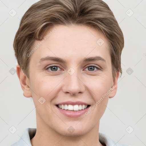 Joyful white young-adult female with short  brown hair and grey eyes