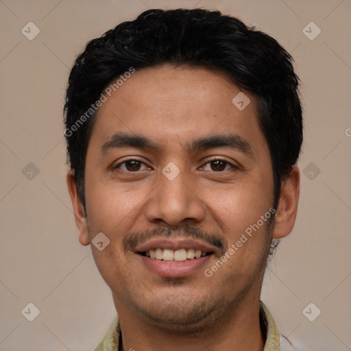 Joyful latino young-adult male with short  black hair and brown eyes