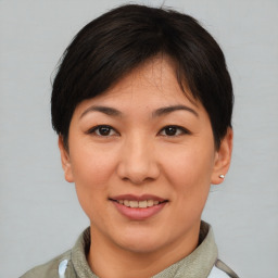 Joyful asian young-adult female with short  brown hair and brown eyes