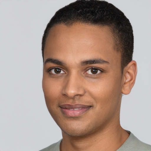 Joyful black young-adult male with short  black hair and brown eyes