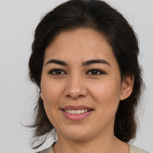 Joyful latino young-adult female with medium  brown hair and brown eyes