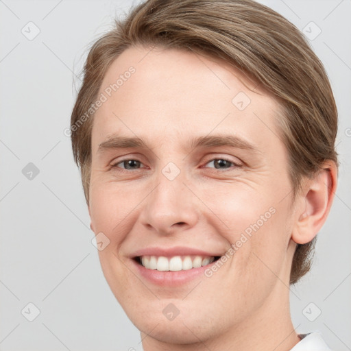 Joyful white young-adult female with short  brown hair and grey eyes