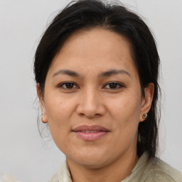 Joyful asian adult female with medium  brown hair and brown eyes