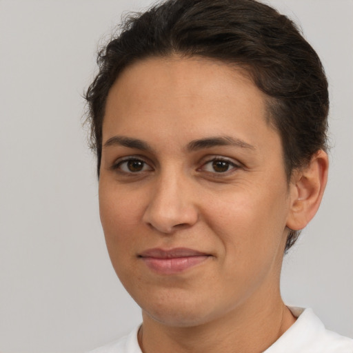 Joyful white young-adult female with short  brown hair and brown eyes