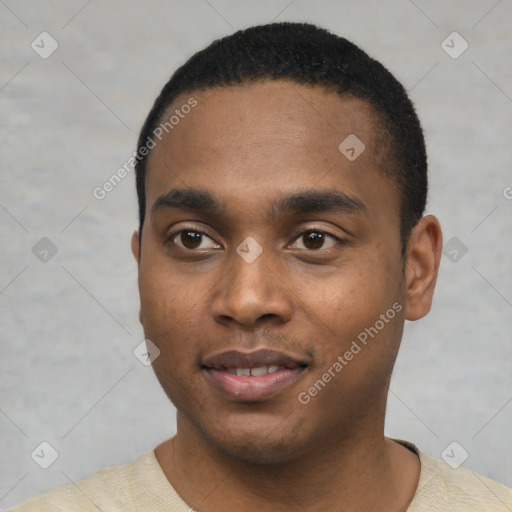 Joyful black young-adult male with short  black hair and brown eyes