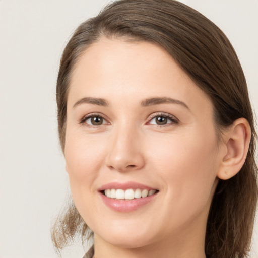 Joyful white young-adult female with long  brown hair and grey eyes