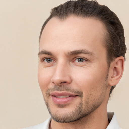 Joyful white young-adult male with short  brown hair and brown eyes