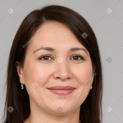 Joyful white adult female with long  brown hair and brown eyes