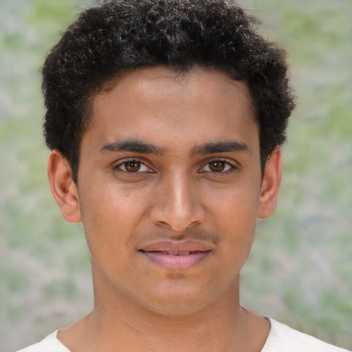 Joyful latino young-adult male with short  brown hair and brown eyes