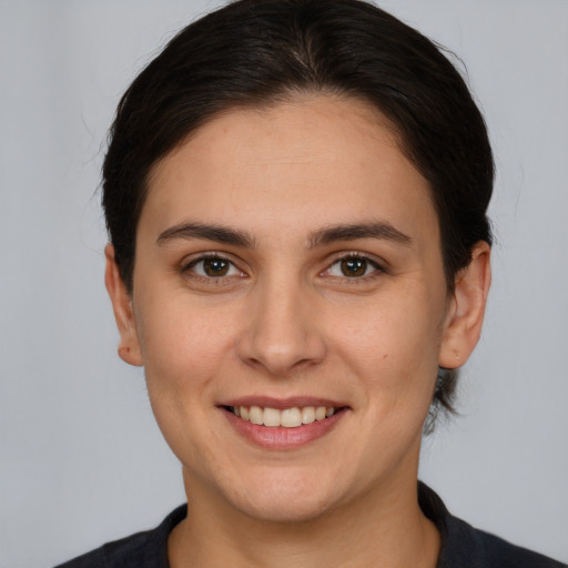 Joyful white young-adult female with medium  brown hair and brown eyes