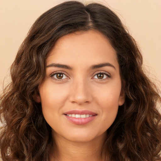 Joyful white young-adult female with long  brown hair and brown eyes