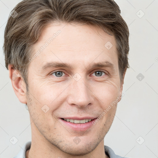 Joyful white adult male with short  brown hair and grey eyes