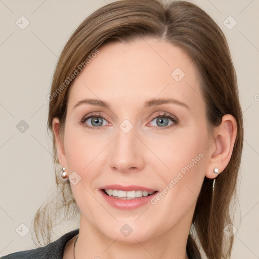 Joyful white young-adult female with medium  brown hair and grey eyes