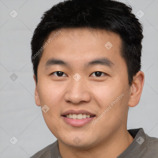 Joyful asian young-adult male with short  black hair and brown eyes