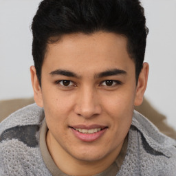 Joyful latino young-adult male with short  brown hair and brown eyes