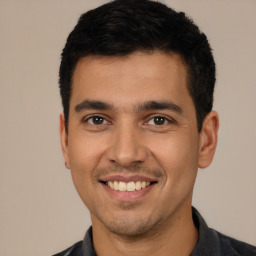 Joyful white young-adult male with short  black hair and brown eyes