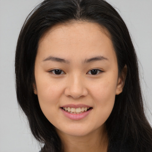 Joyful asian young-adult female with long  brown hair and brown eyes