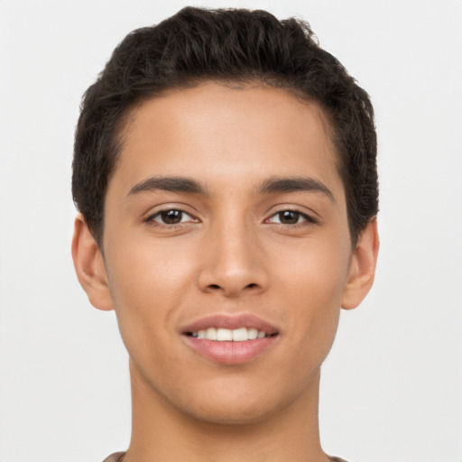 Joyful latino young-adult male with short  brown hair and brown eyes