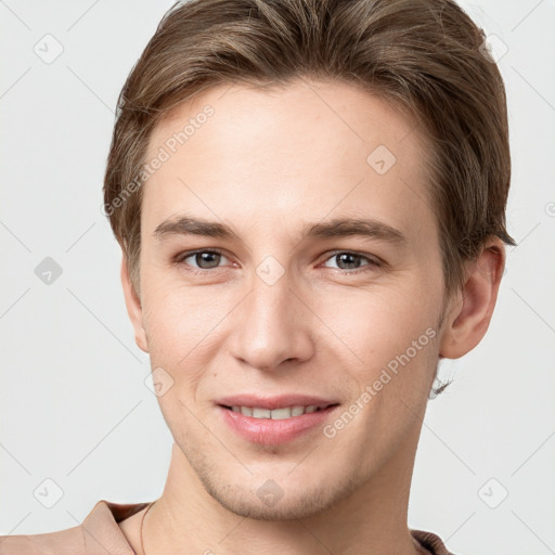 Joyful white young-adult male with short  brown hair and grey eyes