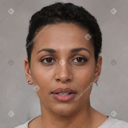 Joyful black young-adult female with short  black hair and brown eyes