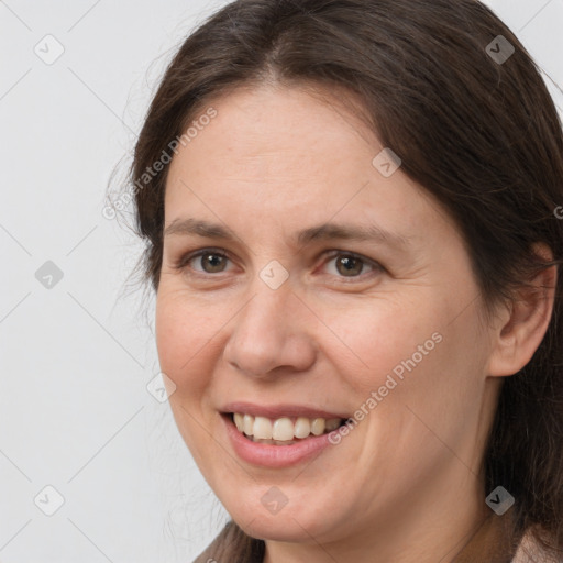 Joyful white adult female with medium  brown hair and brown eyes