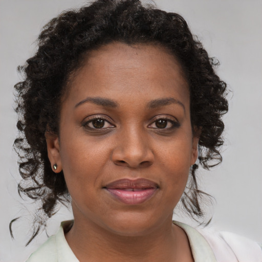Joyful black young-adult female with medium  brown hair and brown eyes