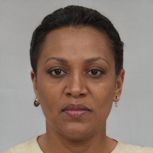 Joyful black adult female with short  brown hair and brown eyes