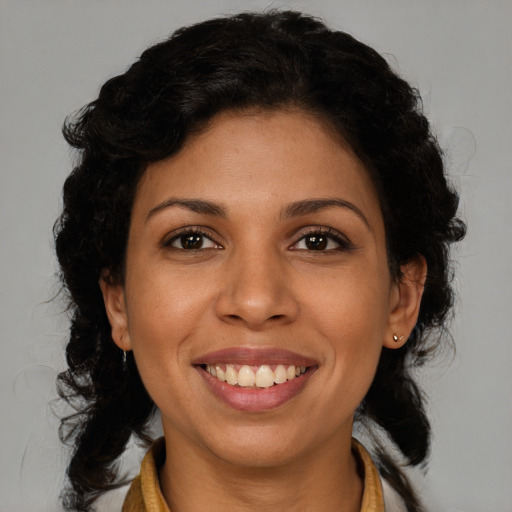 Joyful latino young-adult female with medium  brown hair and brown eyes