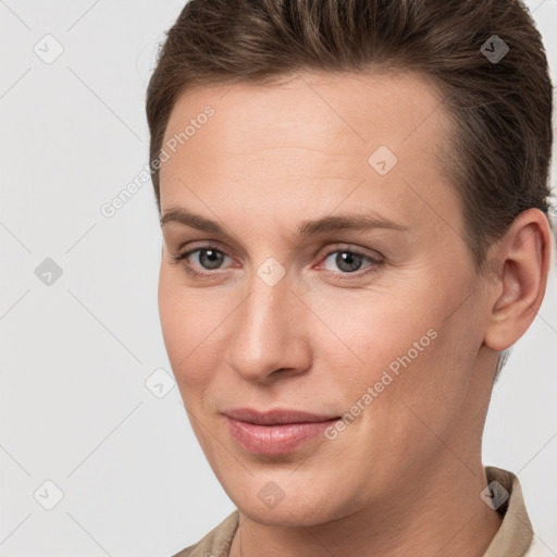 Joyful white young-adult female with short  brown hair and grey eyes