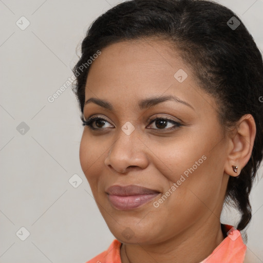 Joyful black young-adult female with long  brown hair and brown eyes