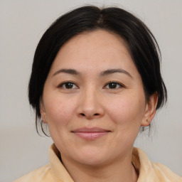 Joyful white adult female with medium  brown hair and brown eyes