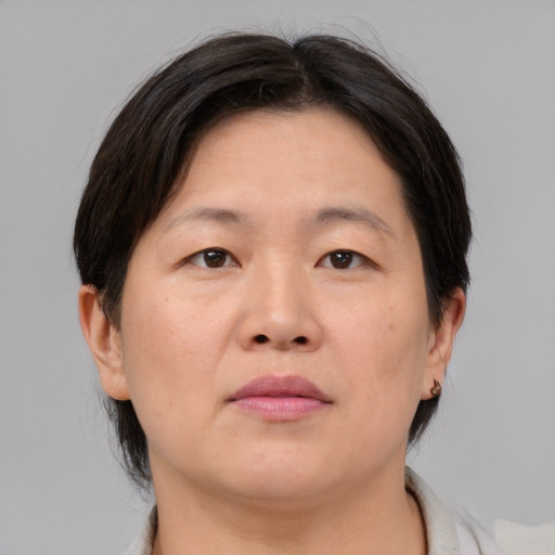 Neutral asian adult female with medium  brown hair and brown eyes