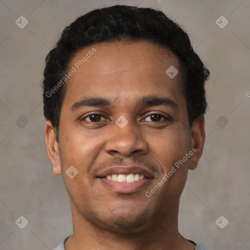 Joyful black young-adult male with short  brown hair and brown eyes