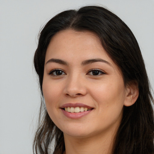 Joyful asian young-adult female with long  brown hair and brown eyes