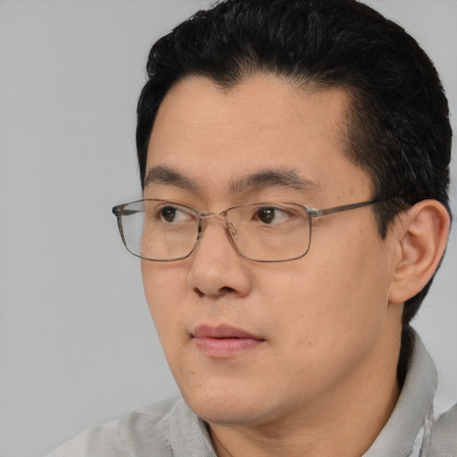 Neutral asian adult male with short  black hair and brown eyes