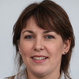 Joyful white adult female with medium  brown hair and brown eyes