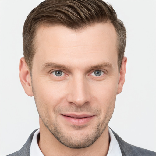 Joyful white young-adult male with short  brown hair and grey eyes